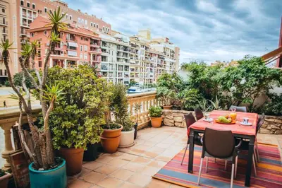 a patio with a table and chairs and plants at Vacansis Port Saplaya 2 in Port Saplaya