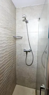 a bedroom with a bed with a flowered blanket on it at Vacansis Port Saplaya 2 in Port Saplaya