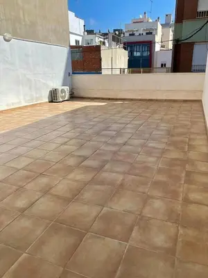 an empty rooftop with a tile floor on a building at UIM Mediterraneo CASA Gomez Ferrer Wifi in Puerto de Sagunto