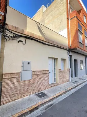 a brick building with a door on the side of it at UIM Mediterraneo CASA Gomez Ferrer Wifi in Puerto de Sagunto