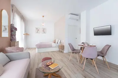 a living room with a couch and a table at SOHO BY THE SEA Valencia in Valencia