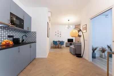 a kitchen and a living room with a table at SOHO BY THE SEA Valencia in Valencia