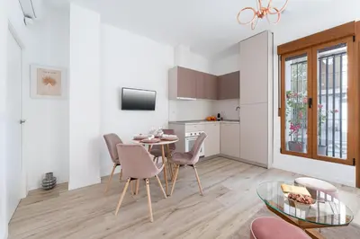 a kitchen and dining room with a table and chairs at SOHO BY THE SEA Valencia in Valencia