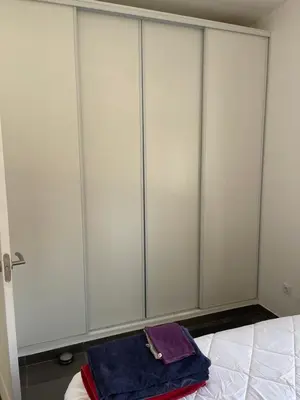 a row of white wardrobes in a bedroom at El Refujio maison independante avec vraie piscine privée au sel chauffee pas de chlore in Turís