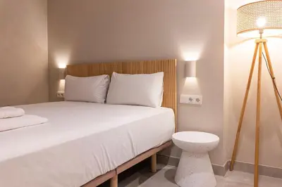 a bedroom with a bed with a lamp and a white bed sidx sidx sidx sidx at VLC HOST - Molina del Palau in Valencia