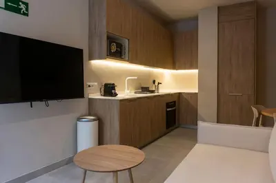 a room with a kitchen with a tv and a table at VLC HOST - Molina del Palau in Valencia
