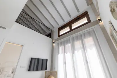 a living room with a window and a tv at ApartUP Ca La Leni Beach IV in Valencia