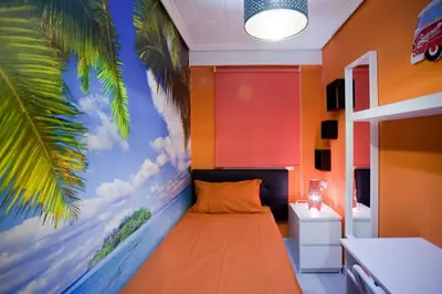 a bedroom with a bed with a palm tree mural at 4-Bed Sleeps 7 Free Parking in Valencia