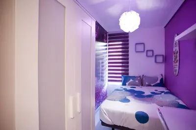 a bedroom with a bed in a purple room at 4-Bed Sleeps 7 Free Parking in Valencia