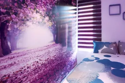 a bedroom with a wall covered in pink flowers at 4-Bed Sleeps 7 Free Parking in Valencia