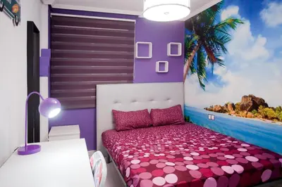 a bedroom with a purple and white bed and a palm tree at 4-Bed Sleeps 7 Free Parking in Valencia