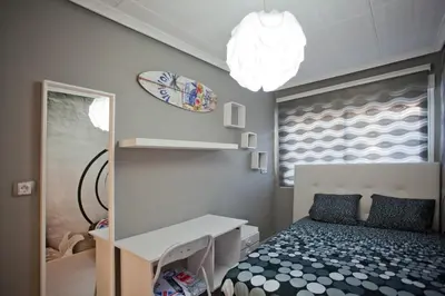 a bedroom with a bed and a desk and a mirror at 4-Bed Sleeps 7 Free Parking in Valencia
