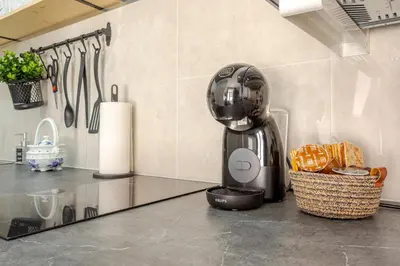 a kitchen counter with a mixer and a basket of bread at NUEVO Apartamentos Costa del Alma in Valencia