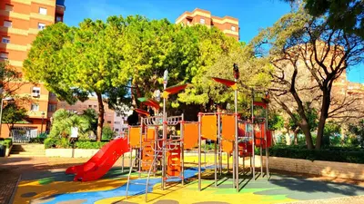a playground with a red slide in a park at NUEVO Apartamentos Costa del Alma in Valencia