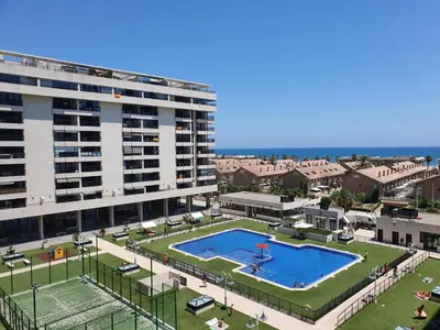 a large swimming pool in front of a building at APARTAMENTO Playa Patacona VALENCIA in Valencia