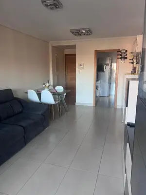 a living room with a couch and a table and a kitchen at APARTAMENTO Playa Patacona VALENCIA in Valencia