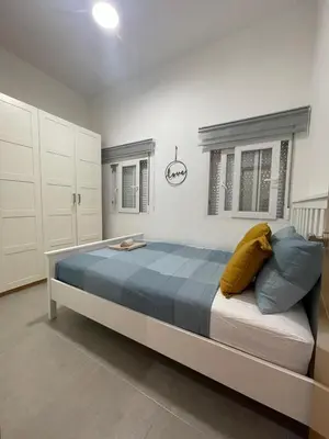 a bedroom with a bed with blue and yellow pillows at uim mediterraneio PB vicente andres estelles wifi in Puerto de Sagunto
