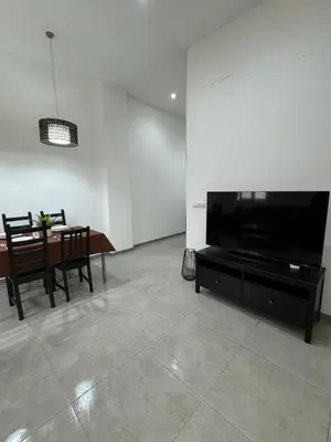 a living room with a large flat screen tv and a table at uim mediterraneio PB vicente andres estelles wifi in Puerto de Sagunto