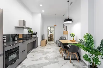 a kitchen with a table and a dining room at New Apartment 1 ROOM,4 pax,wifi, ACRuzafa market in Valencia