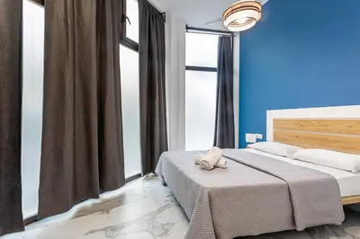 a bedroom with two beds and a large window at New Apartment 1 ROOM,4 pax,wifi, ACRuzafa market in Valencia