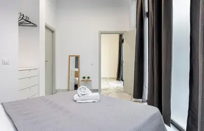 a bedroom with a bed with a towel on it at New Apartment 1 ROOM,4 pax,wifi, ACRuzafa market in Valencia