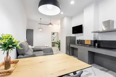 a kitchen and living room with a table and a couch at New Loft Ruzafa market, wifi AC in Valencia