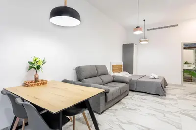 a living room with a couch and a table at New Loft Ruzafa market, wifi AC in Valencia