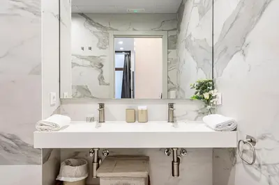 a white bathroom with a sink and a mirror at New Loft Ruzafa market, wifi AC in Valencia