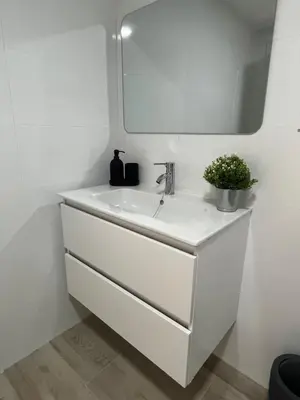 a white bathroom with a sink and a mirror at Apartamentos ESPIGAS PUERTO in Valencia