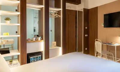 a bedroom with a bed and a tv and a fireplace at Axel Hotel Valencia - Adults Only in Valencia