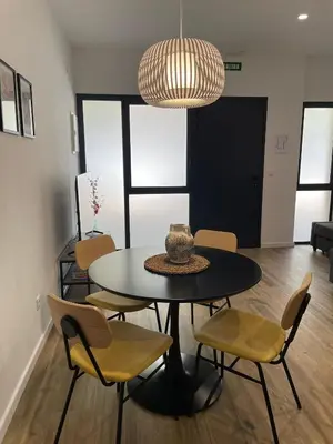 a dining room with a black table and chairs at Junto al Jardín del Turia Apartamento in Valencia