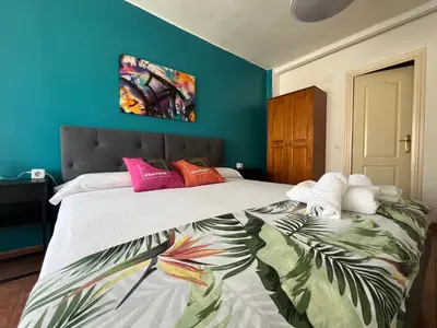 a bedroom with a large bed with colorful pillows at Valencia nuevo centro in Valencia