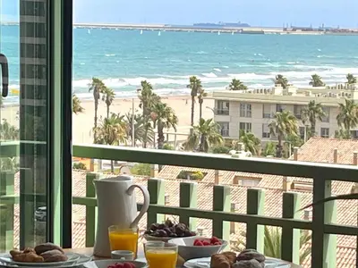 a table with food and a view of the beach at Stylish well-connected beachfront flat in Valencia