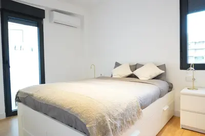 a kitchen with white cabinets and a table with chairs at Apartamento Ático en Valencia in Valencia
