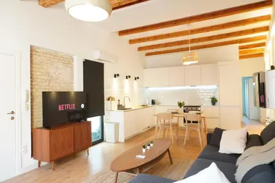 a bathroom with a toilet and a shower with a mirror at Apartamento Ático en Valencia in Valencia