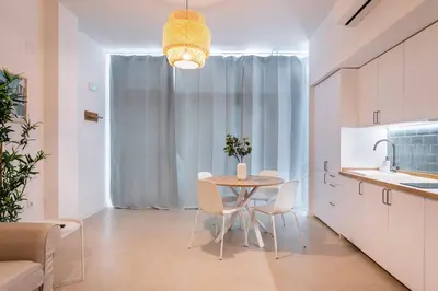 a kitchen with a table and chairs in a room at Julio's Apartment in Valencia