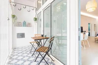 a room with a table and chairs on a patio at Julio's Apartment in Valencia