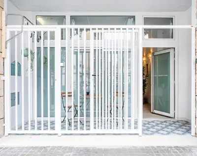 a white gate in front of a house at Julio's Apartment in Valencia