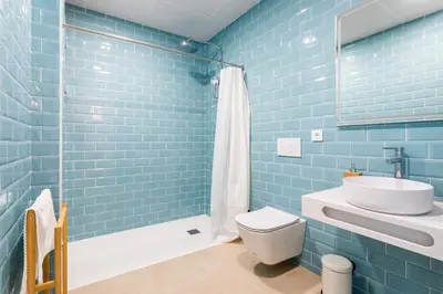 a blue bathroom with a toilet and a sink at Julio's Apartment in Valencia
