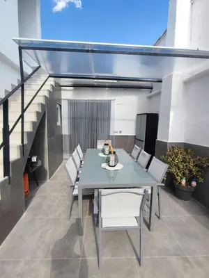a dining room with a table and chairs on a patio at Casa Salvador, Escapada de Aventura y Relax en Buñol in Buñol