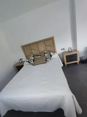 a bedroom with a large bed with white sheets and pillows at Casa Salvador, Escapada de Aventura y Relax en Buñol in Buñol