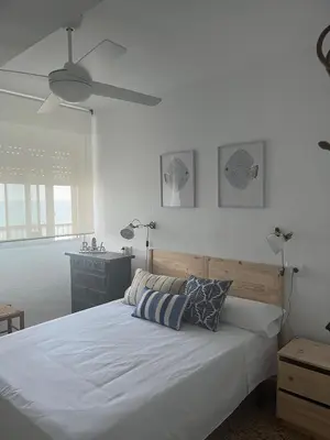 a bedroom with a large white bed with two pillows at Caballito de Mar in Tavernes de Valldigna