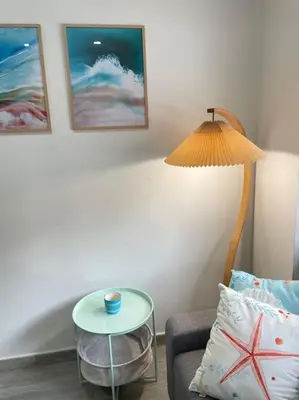 a room with a table and a lamp and a chair at Seahorse apartment El Perelló in El Perelló