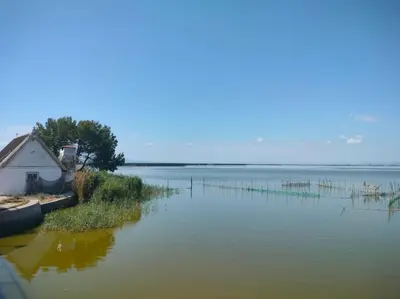 a house in the middle of a large body of water at Seahorse apartment El Perelló in El Perelló
