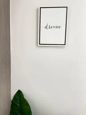 a picture hanging on a wall with a green plant at Seahorse apartment El Perelló in El Perelló