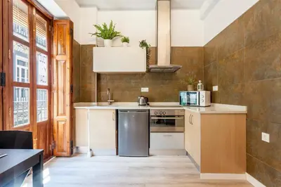 a kitchen with a refrigerator and a stove at Modern Flat by Mercado Central in Ciutat Vella in Valencia