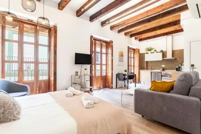 a living room with a bed and a couch at Modern Flat by Mercado Central in Ciutat Vella in Valencia