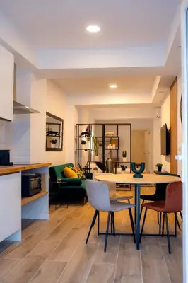 a kitchen and living room with a table and chairs at Green Relax Leones in Valencia