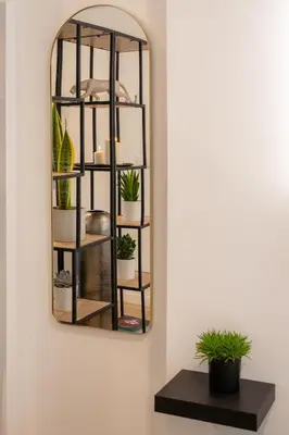 a mirror hanging on a wall with potted plants at Green Relax Leones in Valencia
