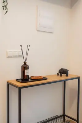 a wooden table with a vase on top of it at Green Relax Leones in Valencia